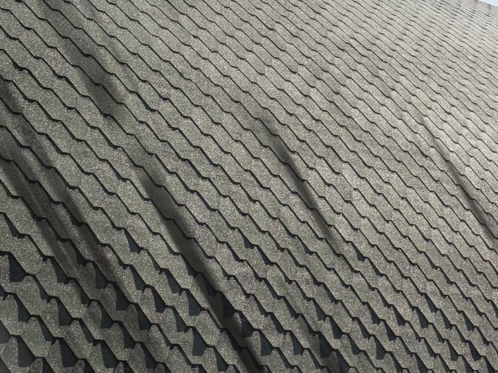 Before: the same roof with dark algae streaks running down the slope